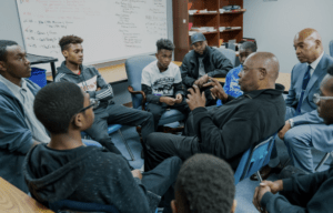 Two experienced men mentoring young adults